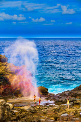 Tourists looking at a blow hole on Maui, Hawaii, USA