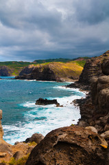 Pacific Ocean waves hitting the rocky coastline of Maui, Hawaii,