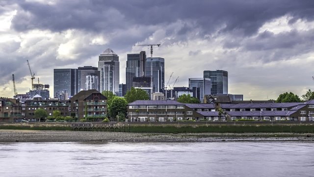 Time lapse of office buildings in Canary Wharf, London, also known as the Docklands financial district. Taken from Greenwich, on the other side of the river Thames