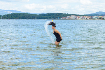 young woman dancing on the shore
