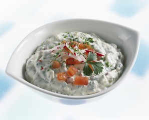 A dish of soft cheese and radish dip