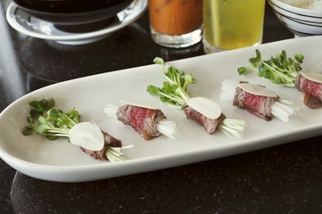 Rolls of beef with sprouts