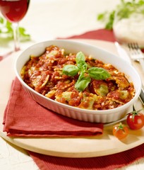 Raviolis with Tomato Sauce in Black Plate