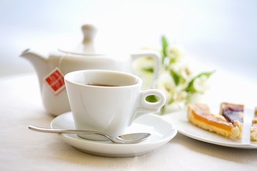 Tea for one with pieces of cake