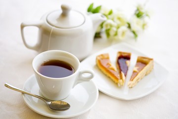 Tea for one with pieces of cake