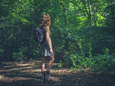 Woman with backpack in forest