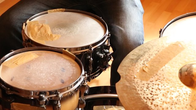 A drummer performing on his Drumset.
