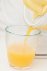 Pouring freshly squeezed orange juice into a glass