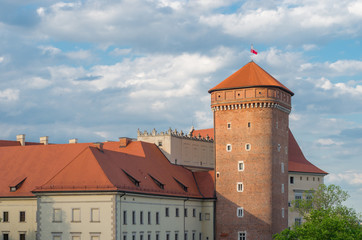 Krakow, Poland, royal castle on the Wawel hill with flying colors of Poland over Senator's tower