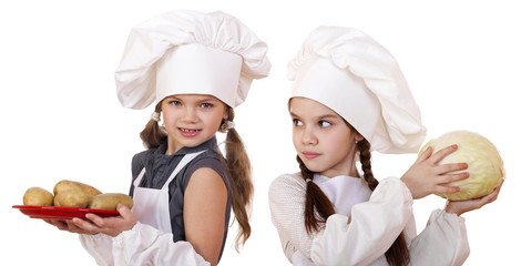 Cooking and people concept - Two Little girls in a white apron