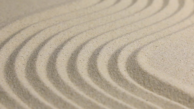Approaching and removing wavy sand, closeup