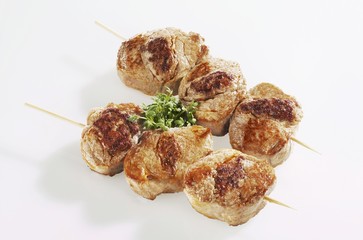 Slices of pork fillet on skewers