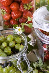 Fresh berries in preserving jars
