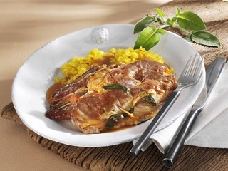 Saltimbocca with saffron rice on plate