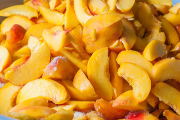 Sliced peaches in syrup. Cooking of peach jam or marmalade