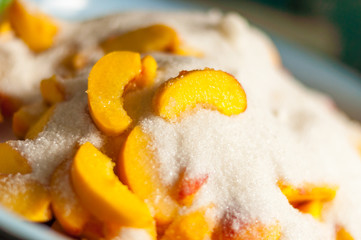 Ripe apricot slices with sugar. Cooking jam. Selective focus and