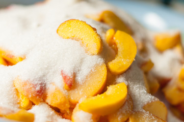 Ripe apricot slices with sugar. Cooking jam. Selective focus and