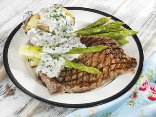 Entrecote steak with green asparagus, baked potato and quark