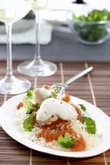 Monkfish with tomato sauce and broccoli on rice