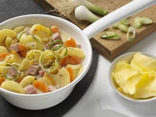 Potato and carrot stew with cured pork and spring onions