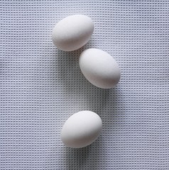 Three eggs on cloth from above