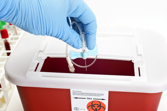 Technician drops catheter into sharps container