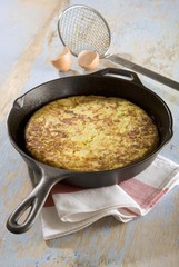 Potato tortilla in frying pan