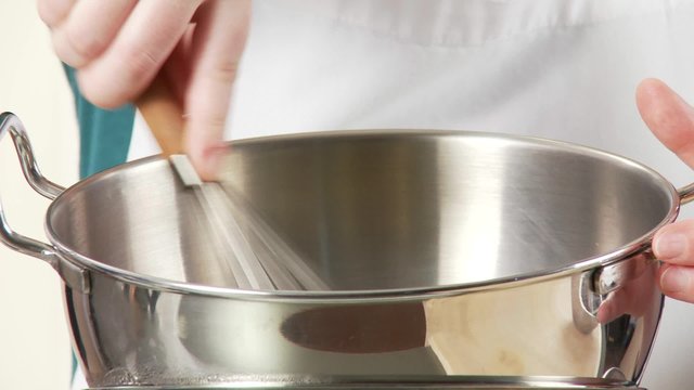 A mixing bowl with a whisk as a bain marie