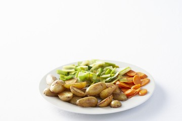 Plate of vegetables: early potatoes, leeks and carrots