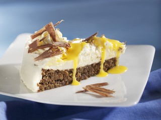 A piece of advocaat cake with nut base