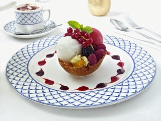 Sorbets with berries in brandy snap basket