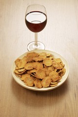 Dish of spelt crackers and a glass of red wine