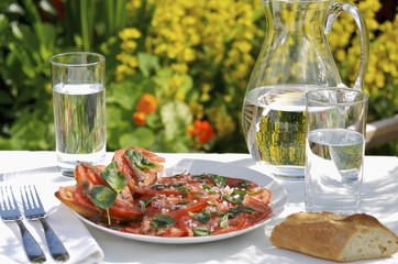 Tomato carpaccio with anchovy fillets and basil