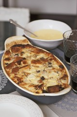 Bread and butter pudding with blueberries and custard