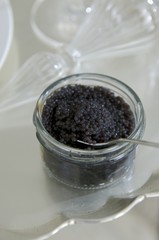 Fototapeta na wymiar Black caviar in jar with spoon