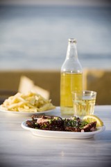 Octopus, chips and white retsina