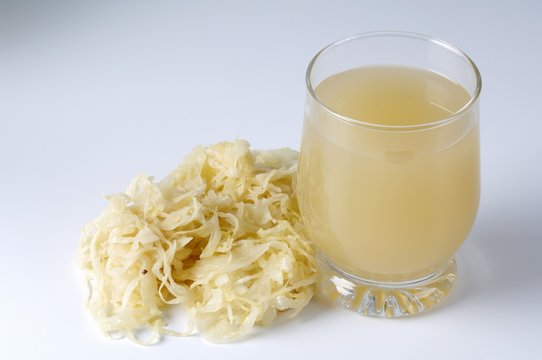 A glass of sauerkraut juice and shredded cabbage