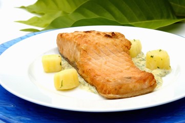 Fried salmon steak on dill sauce