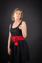 Beautiful woman doing different expressions in different sets of clothes: gun sign