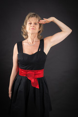 Beautiful woman doing different expressions in different sets of clothes: at attention