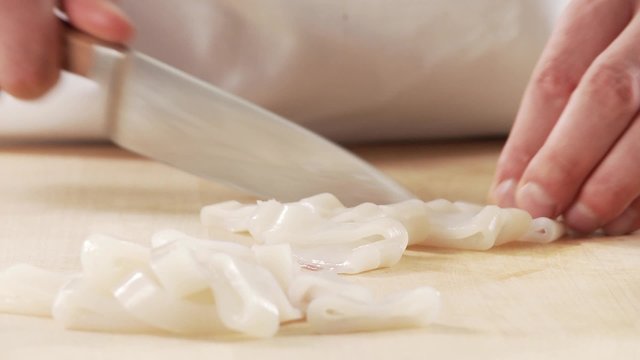 Squid tubes being cut into rings