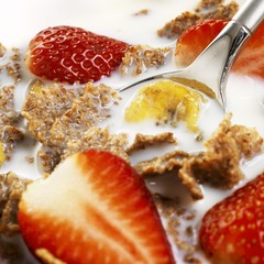 Cereal flakes with milk, strawberries and dried banana