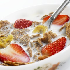 Cereal flakes with milk, strawberries and dried banana