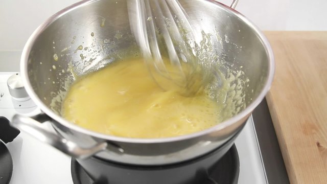 Egg cream being stirred over a bain marie
