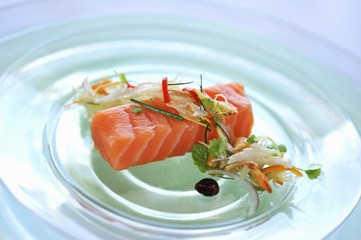 Salmon sashimi with a vegetable garnish
