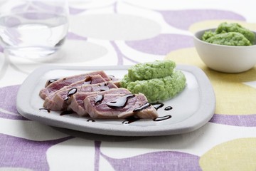 Slices of tuna with balsamic vinegar and broccoli puree