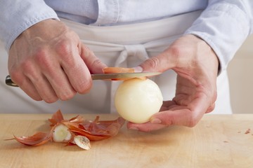An onion being peeled