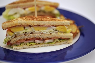 Ham, tomato and egg club sandwich