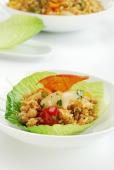 Rice salad with onions and peppers in a lettuce leaf