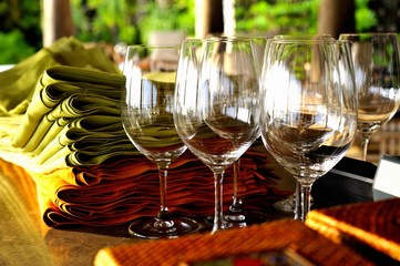 Empty wine glasses and a stack of napkin